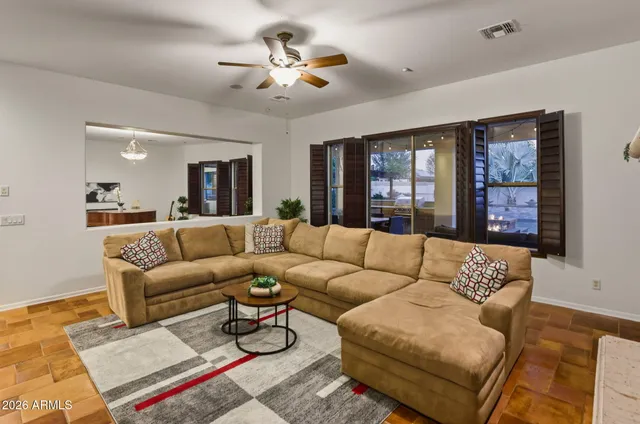 a living room with furniture ceiling fan and a rug