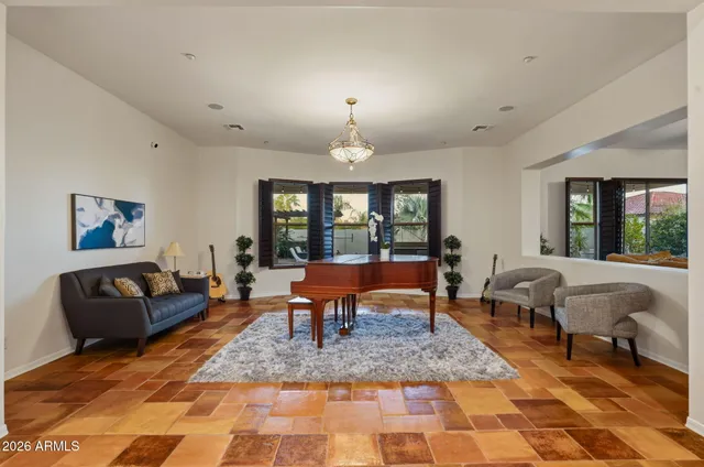 a living room with furniture a rug and a large window
