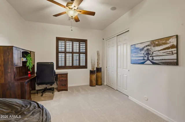 a view of a livingroom with workspace and a window
