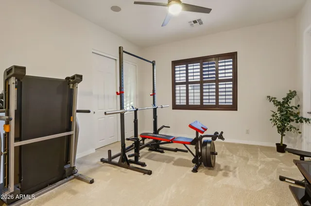 a view of a workspace with furniture and a chandelier