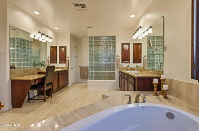 a bathroom with a double vanity sink tub and shower