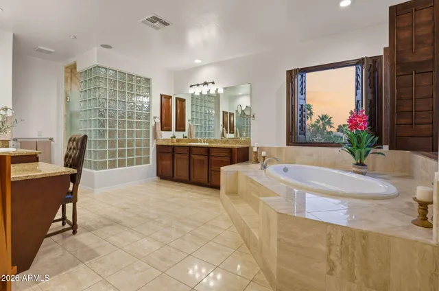 a large white kitchen with a large window