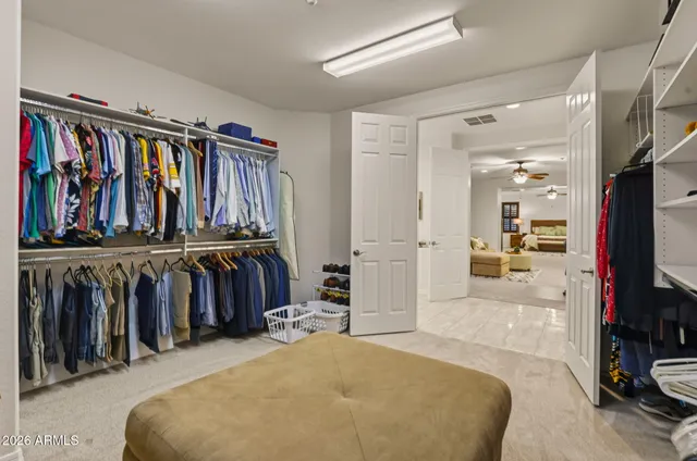 a view of a bedroom with furniture and closet