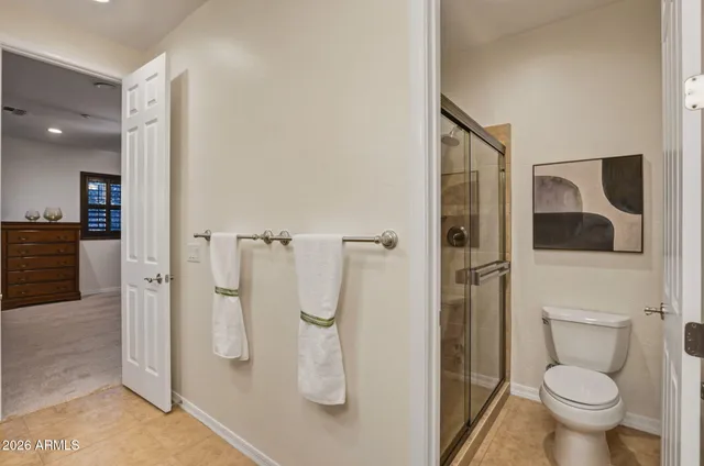 a bedroom with a bed and a ceiling fan