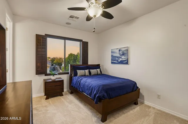 a bathroom with a sink a toilet a mirror and shower