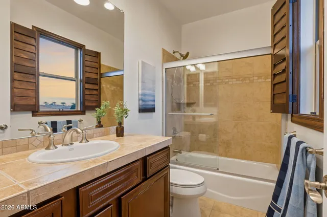 a spacious bedroom with a bed and a chandelier