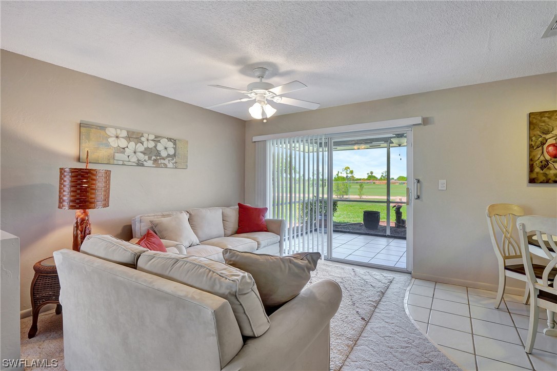 17508 Laurel Valley Road Fort Myers, FL 33967 - Photo 12 of 36 a living room with furniture and a floor to ceiling window