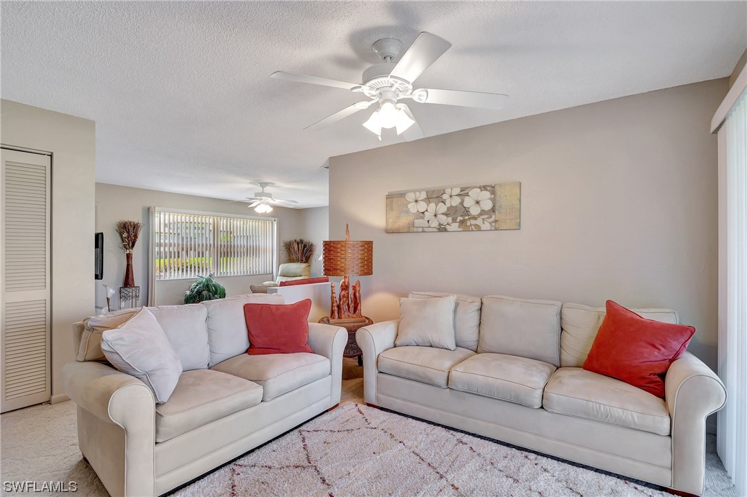 17508 Laurel Valley Road Fort Myers, FL 33967 - Photo 13 of 36 a living room with furniture and a chandelier