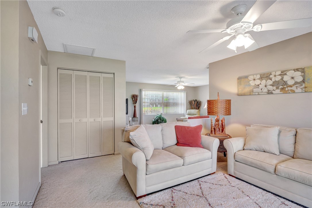 17508 Laurel Valley Road Fort Myers, FL 33967 - Photo 14 of 36 a living room with furniture and a chandelier