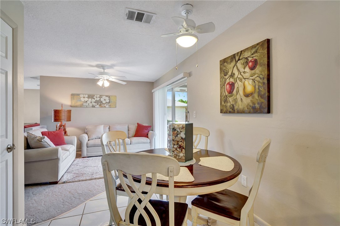 17508 Laurel Valley Road Fort Myers, FL 33967 - Photo 16 of 36 a dining room with furniture and chandelier