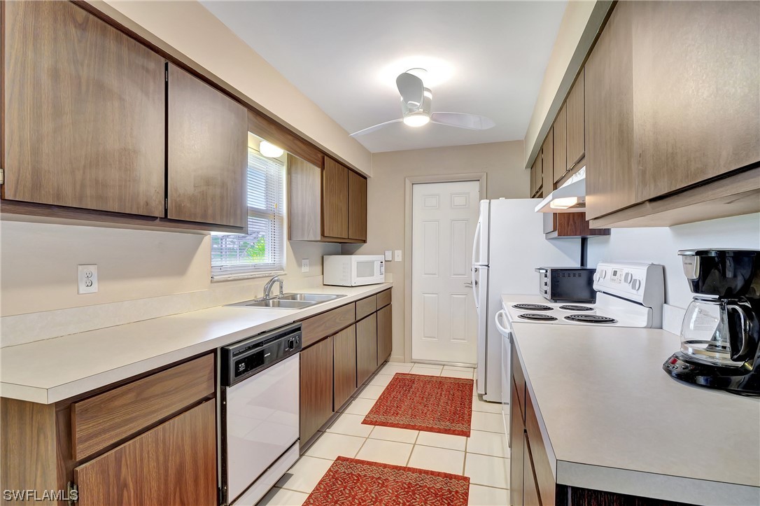 17508 Laurel Valley Road Fort Myers, FL 33967 - Photo 19 of 36 a kitchen with a sink appliances and cabinets