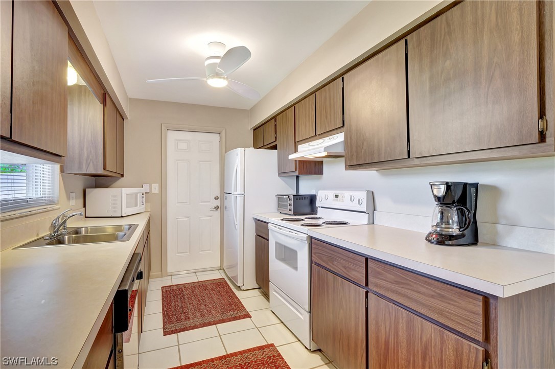 17508 Laurel Valley Road Fort Myers, FL 33967 - Photo 20 of 36 a kitchen with a sink stove and refrigerator