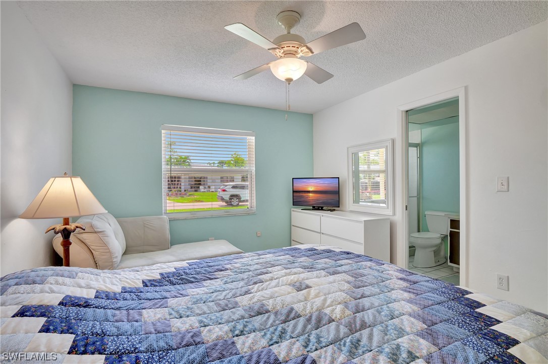17508 Laurel Valley Road Fort Myers, FL 33967 - Photo 29 of 36 a bedroom with a bed and a flat screen tv