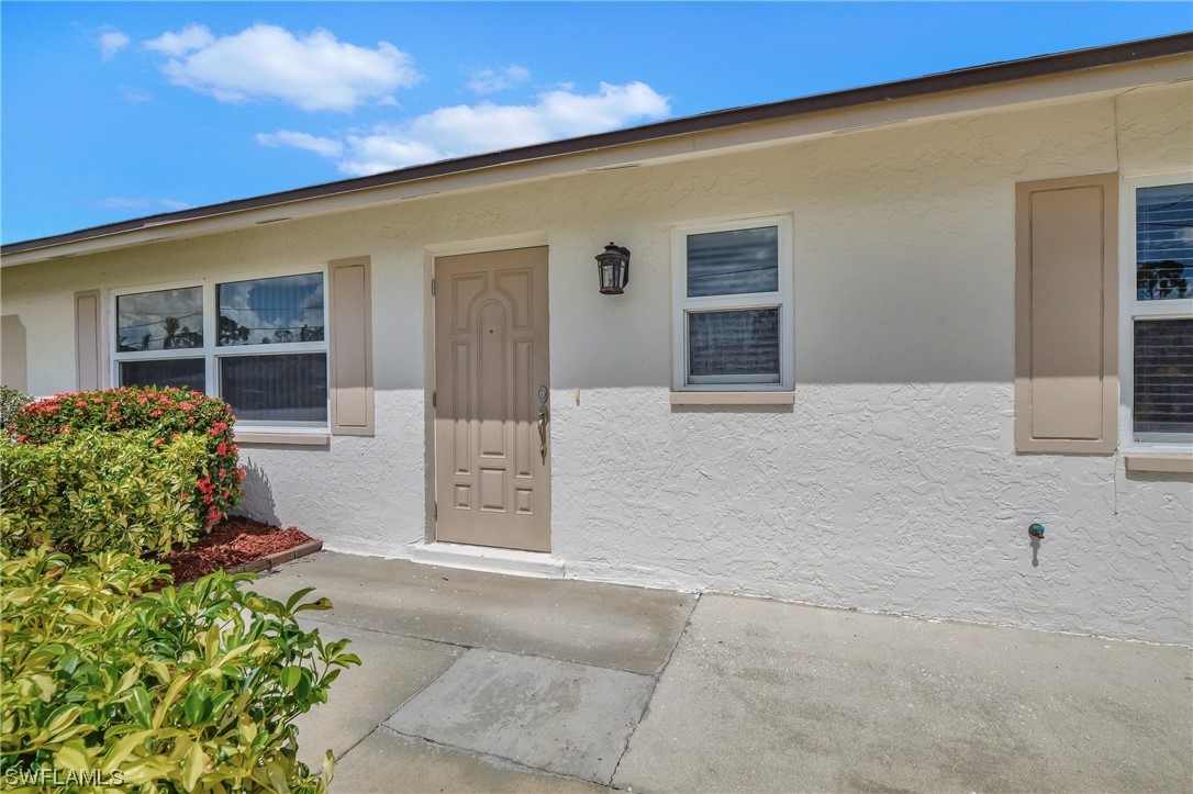 17508 Laurel Valley Road Fort Myers, FL 33967 - Photo 3 of 36 a front view of a house with a yard
