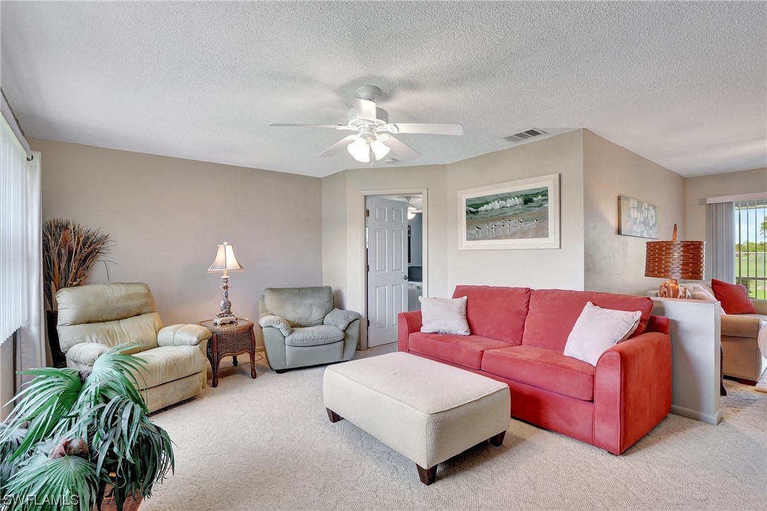 17508 Laurel Valley Road Fort Myers, FL 33967 - Photo 6 of 36 a living room with furniture a chandelier and a rug