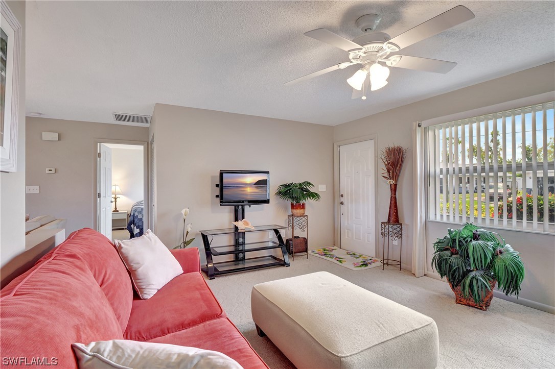 17508 Laurel Valley Road Fort Myers, FL 33967 - Photo 7 of 36 a living room with furniture a chandelier and a window