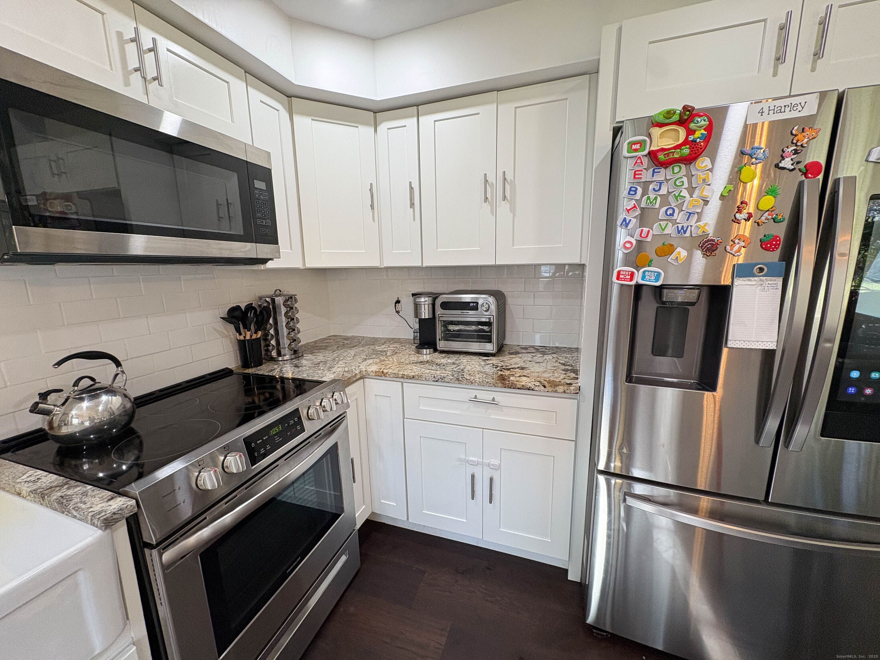32 Karen Court, Unit B Bridgeport, CT 06606 - Photo 9 of 20 a kitchen with stainless steel appliances granite countertop a refrigerator and a stove top oven