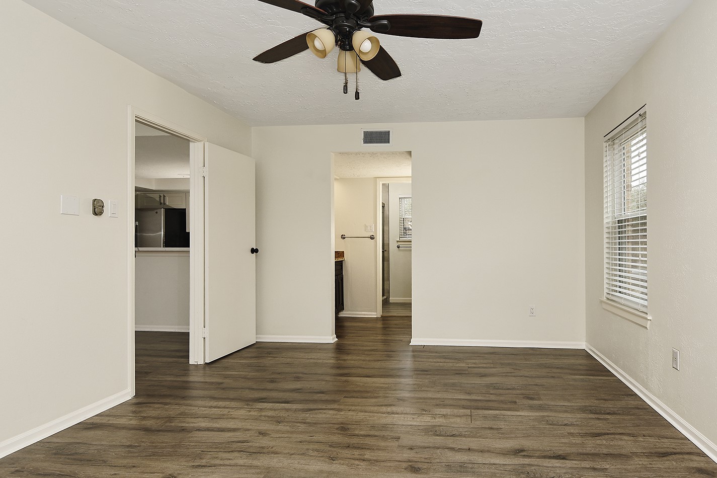 30 Berryfrost Lane Spring, TX 77380 - Photo 12 of 23 a view of an empty room with wooden floor and a ceiling fan
