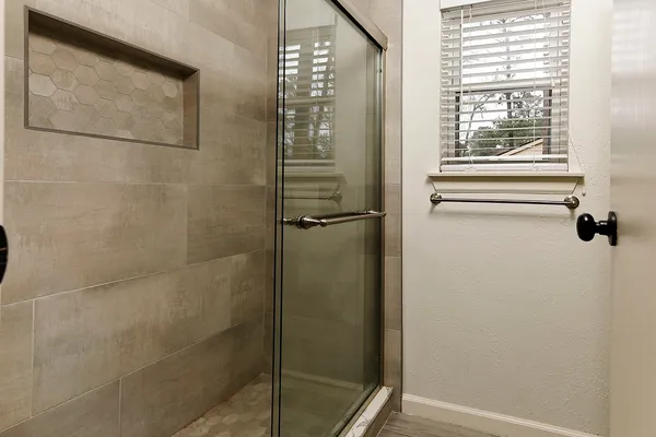 a bathroom with a glass shower door