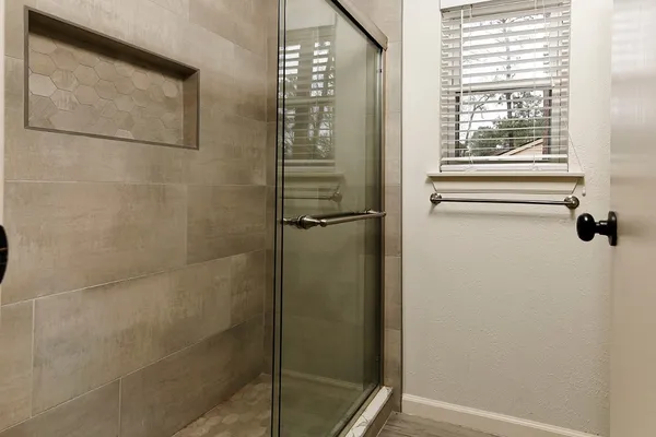 a bathroom with a glass shower door