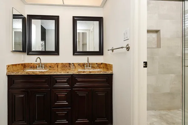 a bathroom with a granite countertop sink a mirror and a