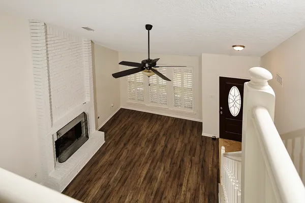a view of a livingroom with furniture wooden floor and chandelier