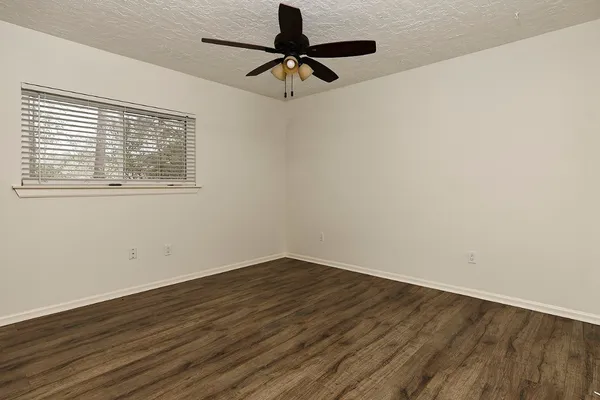 wooden floor in an empty room with a window