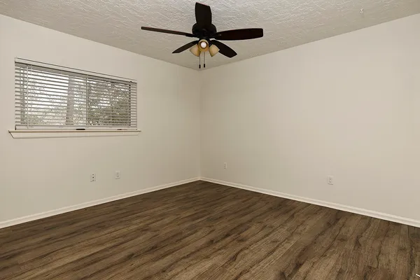wooden floor in an empty room with a window