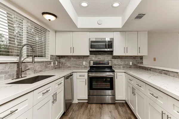 a kitchen with a sink stove and microwave