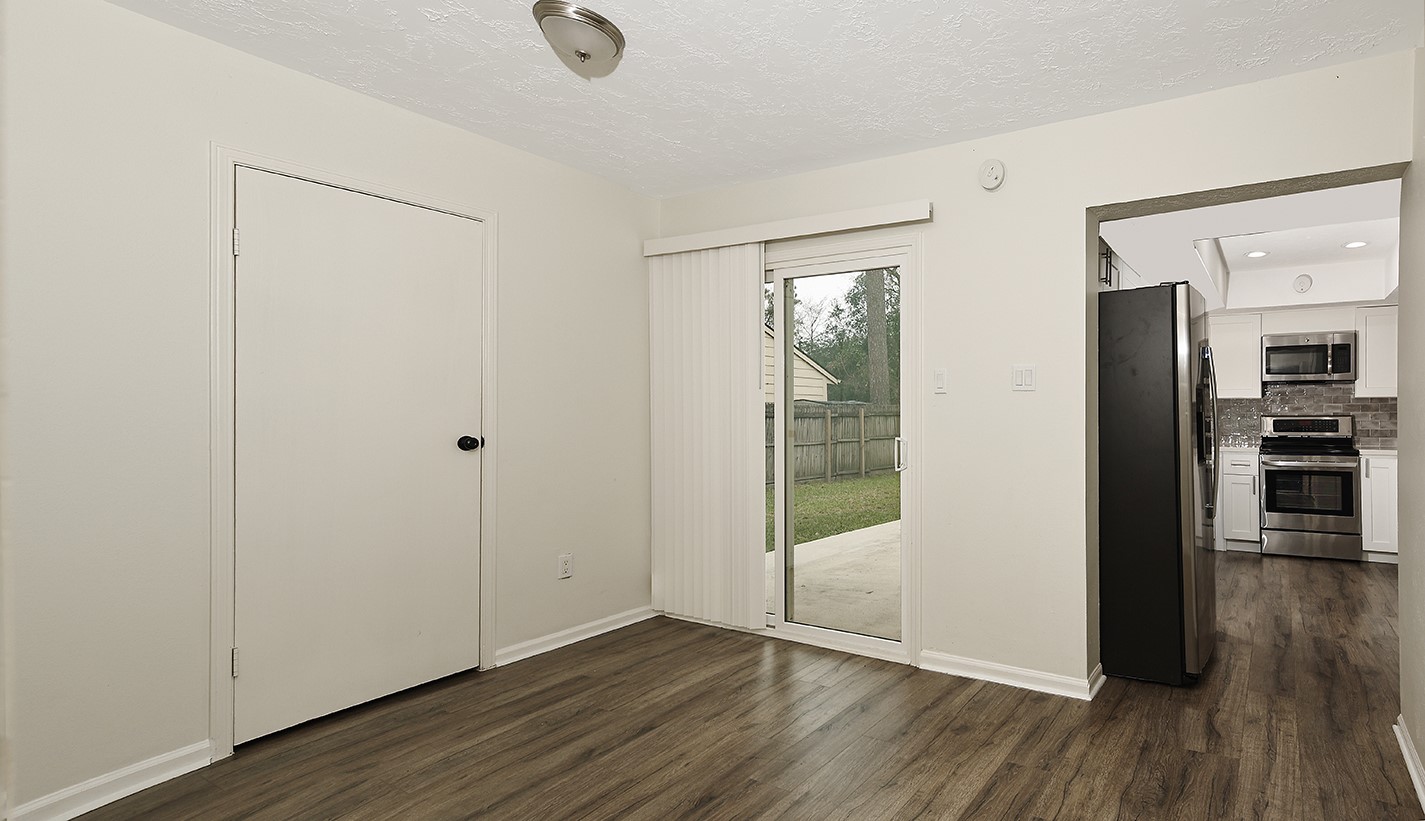 30 Berryfrost Lane Spring, TX 77380 - Photo 9 of 23 a view of an empty room with wooden floor and a window