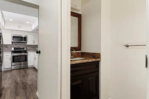 a kitchen with stainless steel appliances granite countertop a stove and a refrigerator
