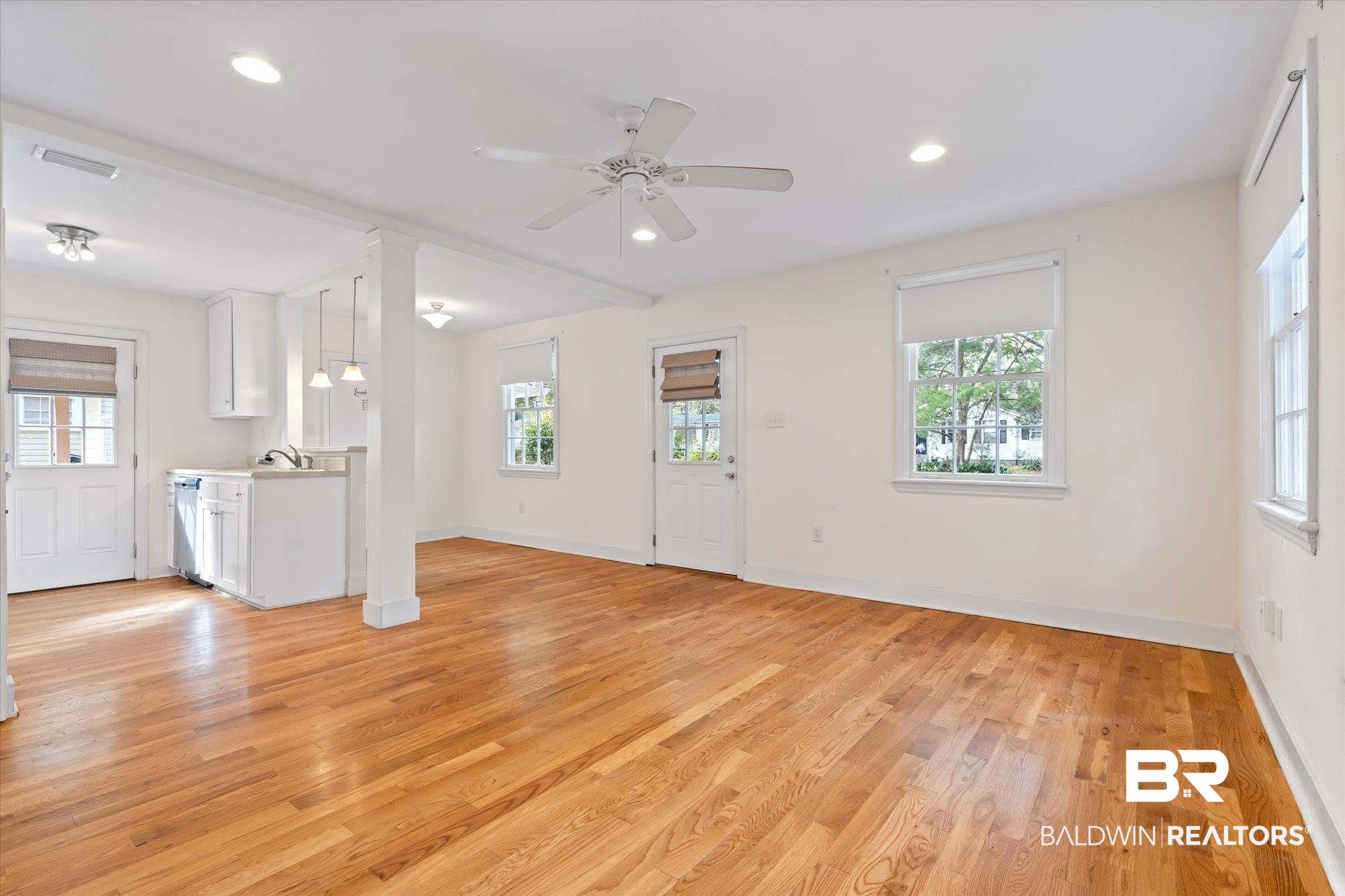 5113 Norton Lane Mobile, AL 36608 - Photo 3 of 20 Unfurnished living room featuring ceiling fan, plenty of natural light, sink, and light hardwood / wood-style flooring