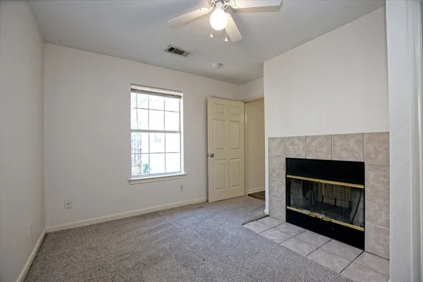 an empty room with fireplace and windows