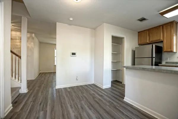 a view of a kitchen with wooden floor and a sink