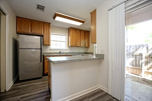 a kitchen with a refrigerator and a sink