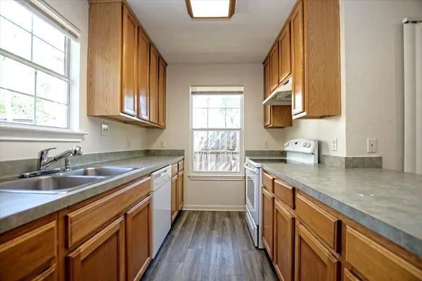a kitchen with a sink a window and cabinets