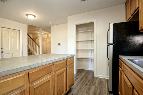 a kitchen with a refrigerator and a sink