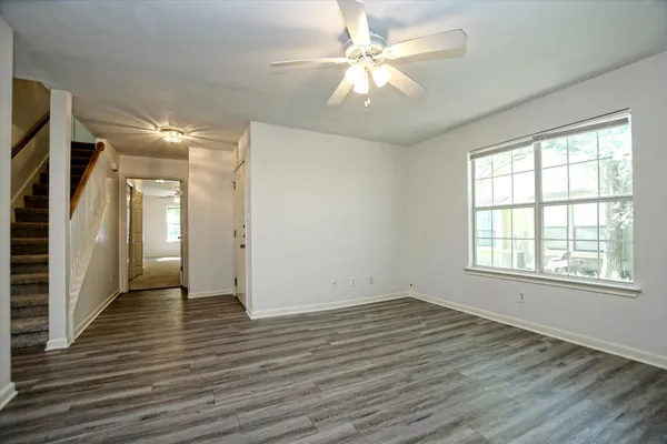 wooden floor in an empty room with a window