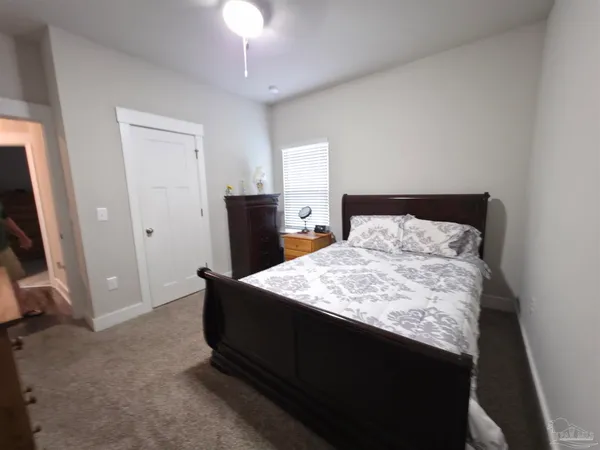 a bedroom with a bed and flat screen tv