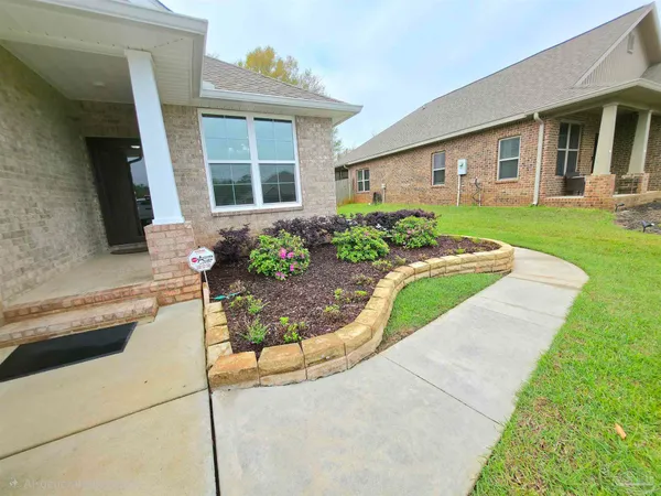 a front view of a house with garden