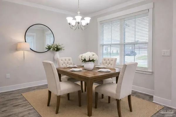 a dining room with furniture a rug and wooden floor