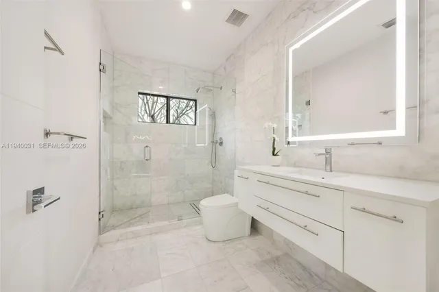 a bathroom with a sink toilet and shower