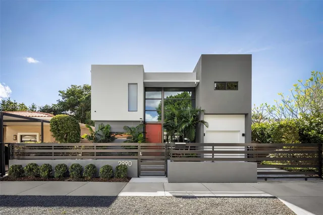 a front view of a house with potted plants