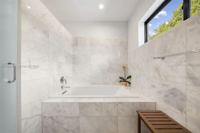 a bathroom with a bathtub and shower
