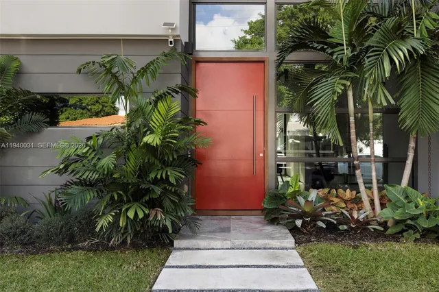 a couple of flower plants in front of house