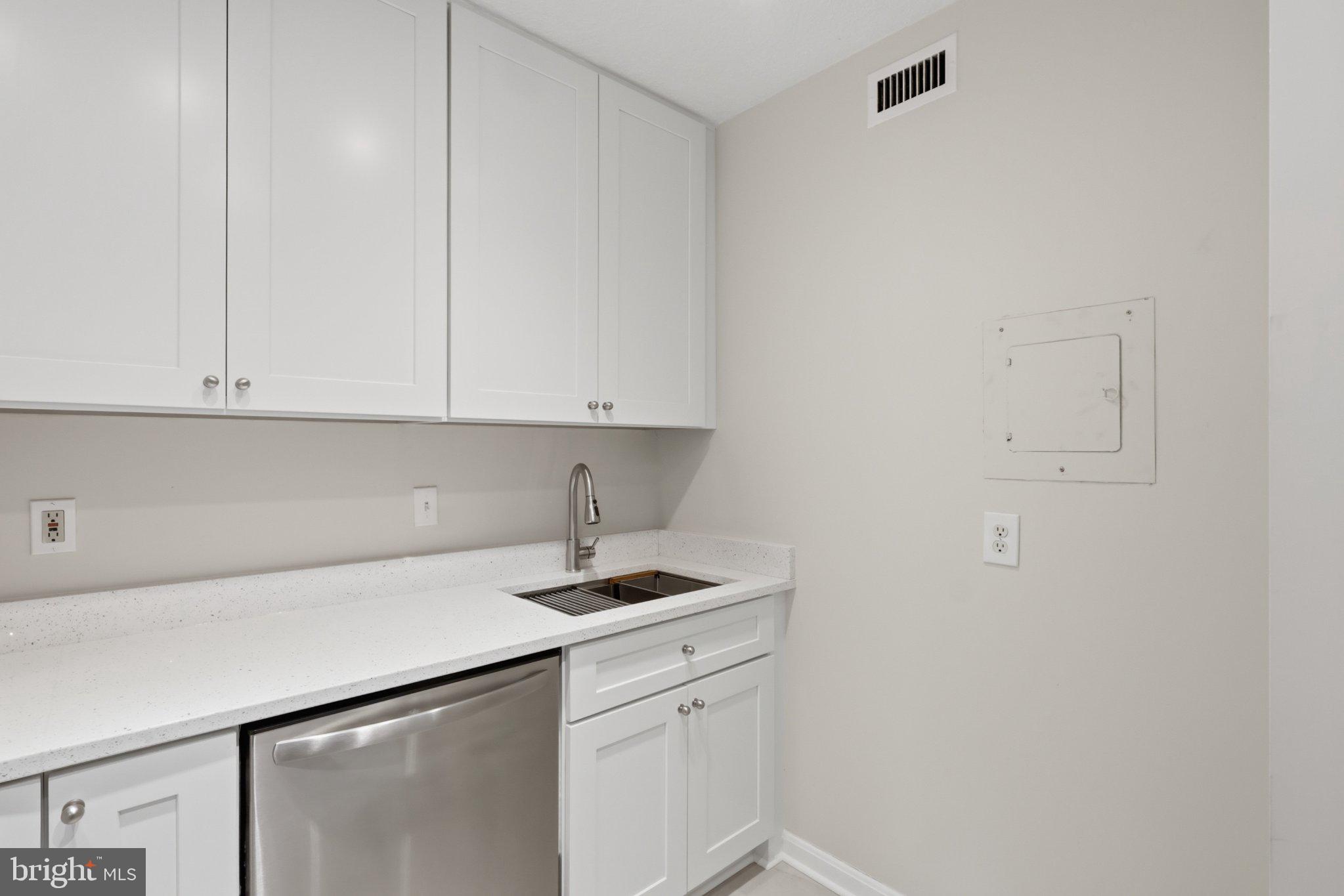 1101 St Paul Street, Unit 1212 Baltimore, MD 21202 - Photo 12 of 36 Sleek modern kitchen with clean lines.