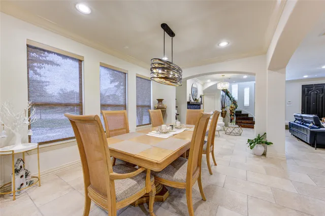 a dining room with furniture a chandelier and wooden floor