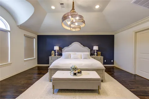 a spacious bedroom with a bed and a window