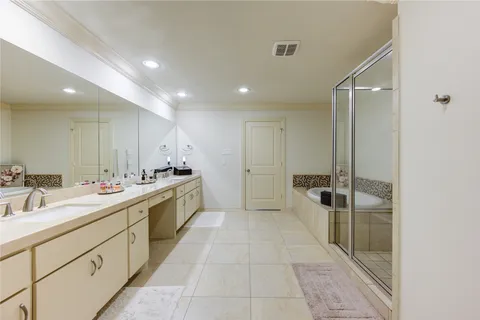 a large bathroom with a double vanity sink a mirror and a shower