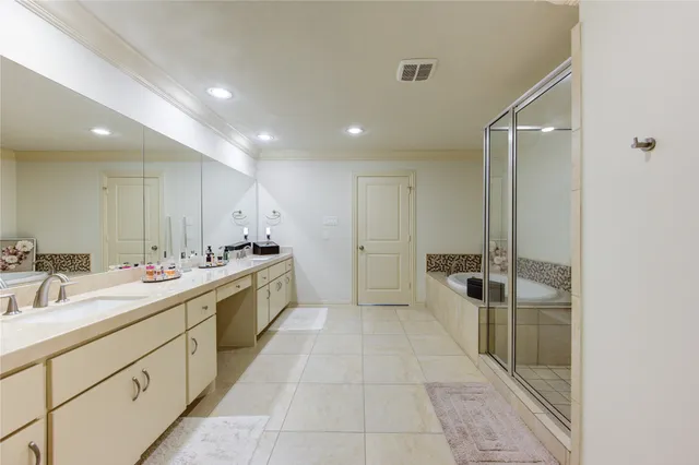a large bathroom with a double vanity sink a mirror and a shower